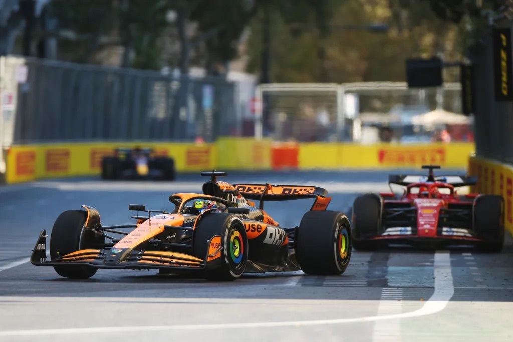 A McLaren F1 car leading a Ferrari