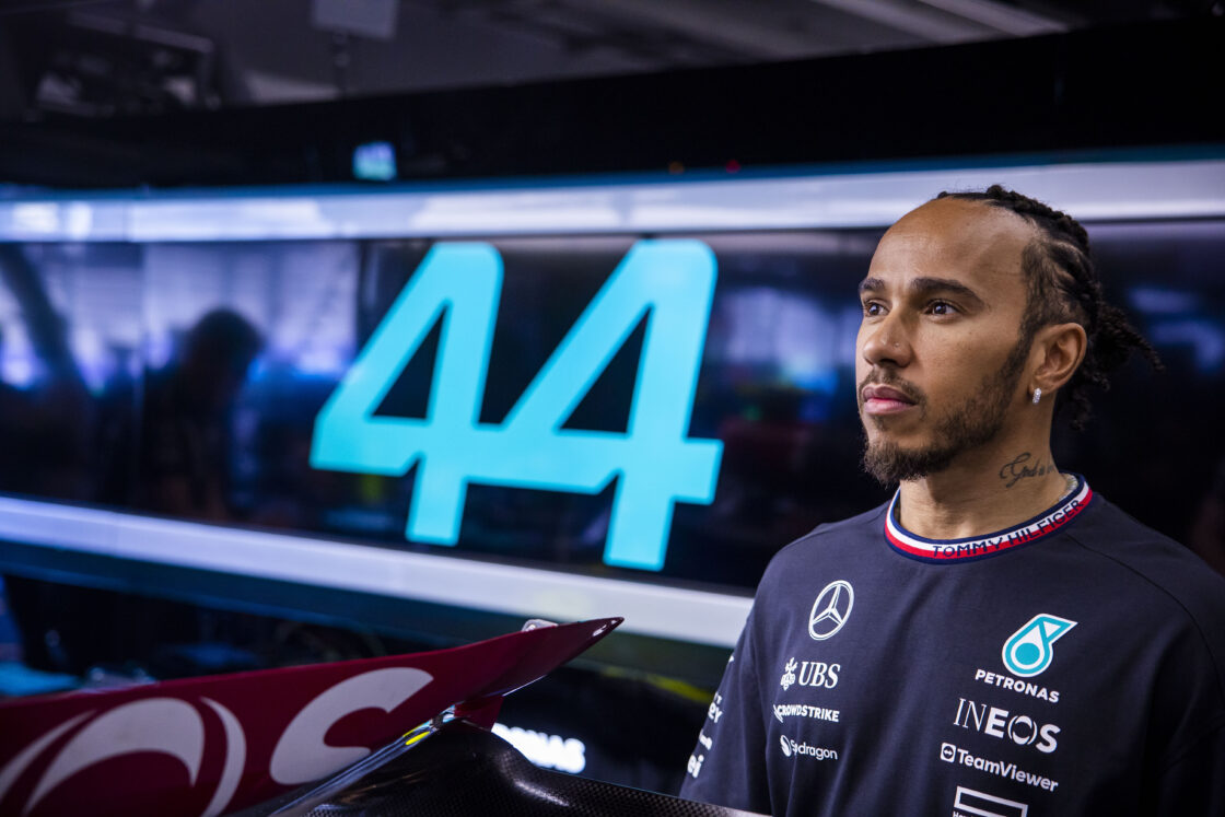 Lewis Hamilton in the Mercedes garage in front of his car number