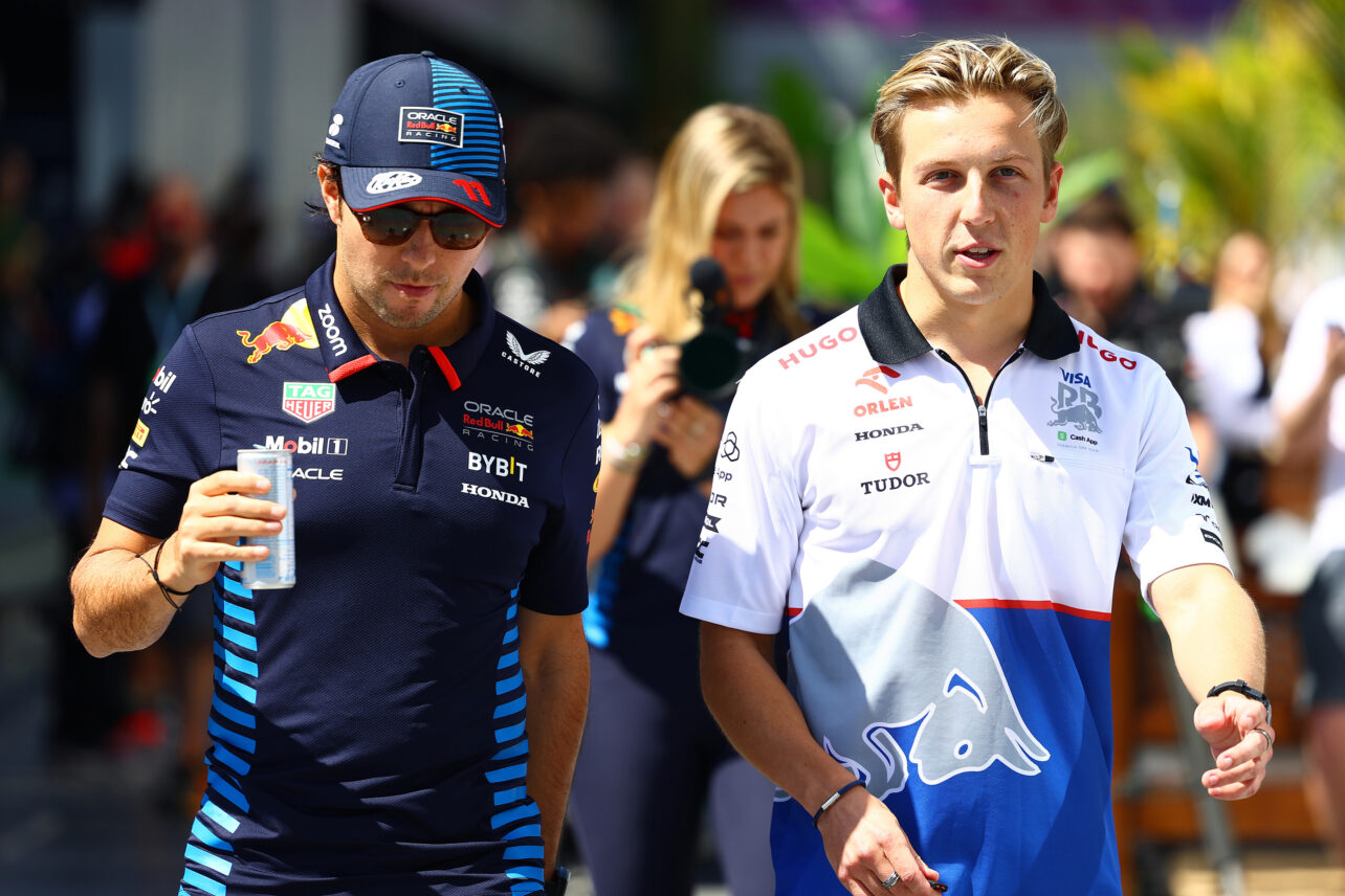 Sergio Perez of Mexico and Oracle Red Bull Racing and Liam Lawson of New Zealand and Visa Cash App RB walk in the Paddock prior to final practice ahead of the F1 Grand Prix of Saudi Arabia at Jeddah Corniche Circuit on March 08, 2024 in Jeddah, Saudi Arabia.