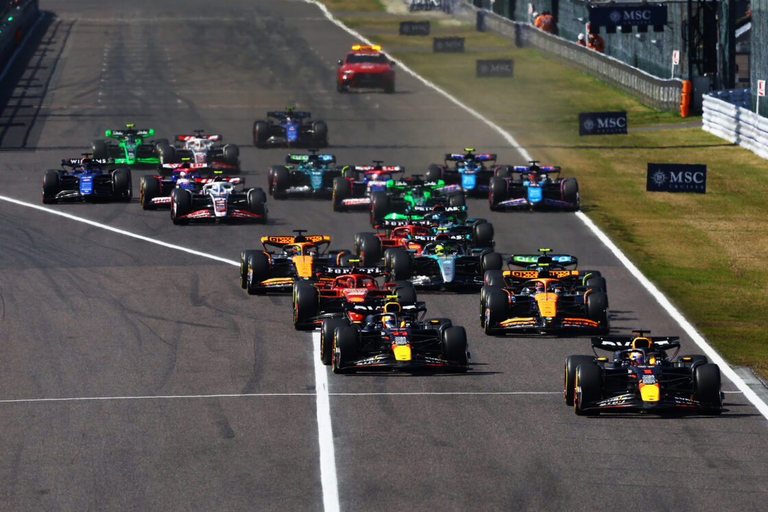 The Formula 1 grid heading into turn 1 at the 2024 Japanese GP shortly after the start